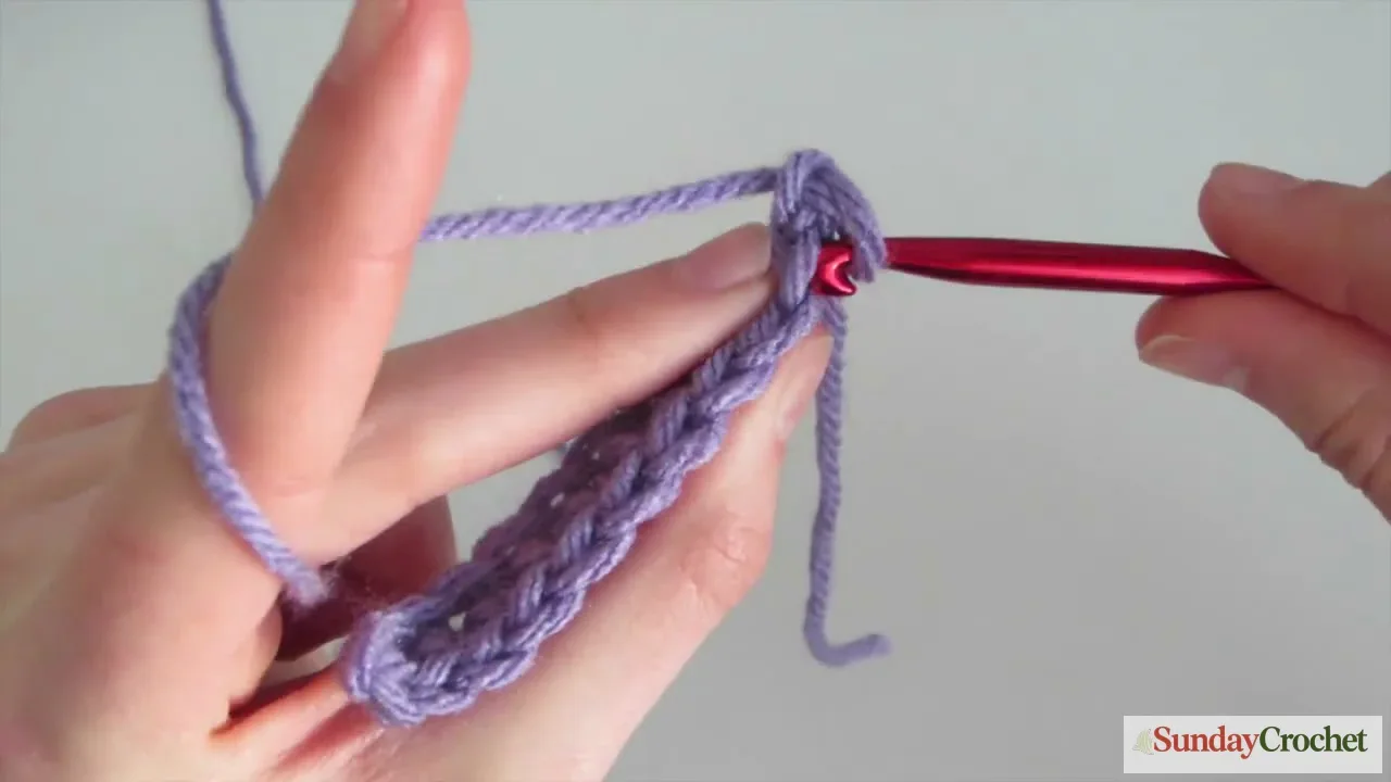 Beginner single-crochet swatch showing stitch tops before starting the next row