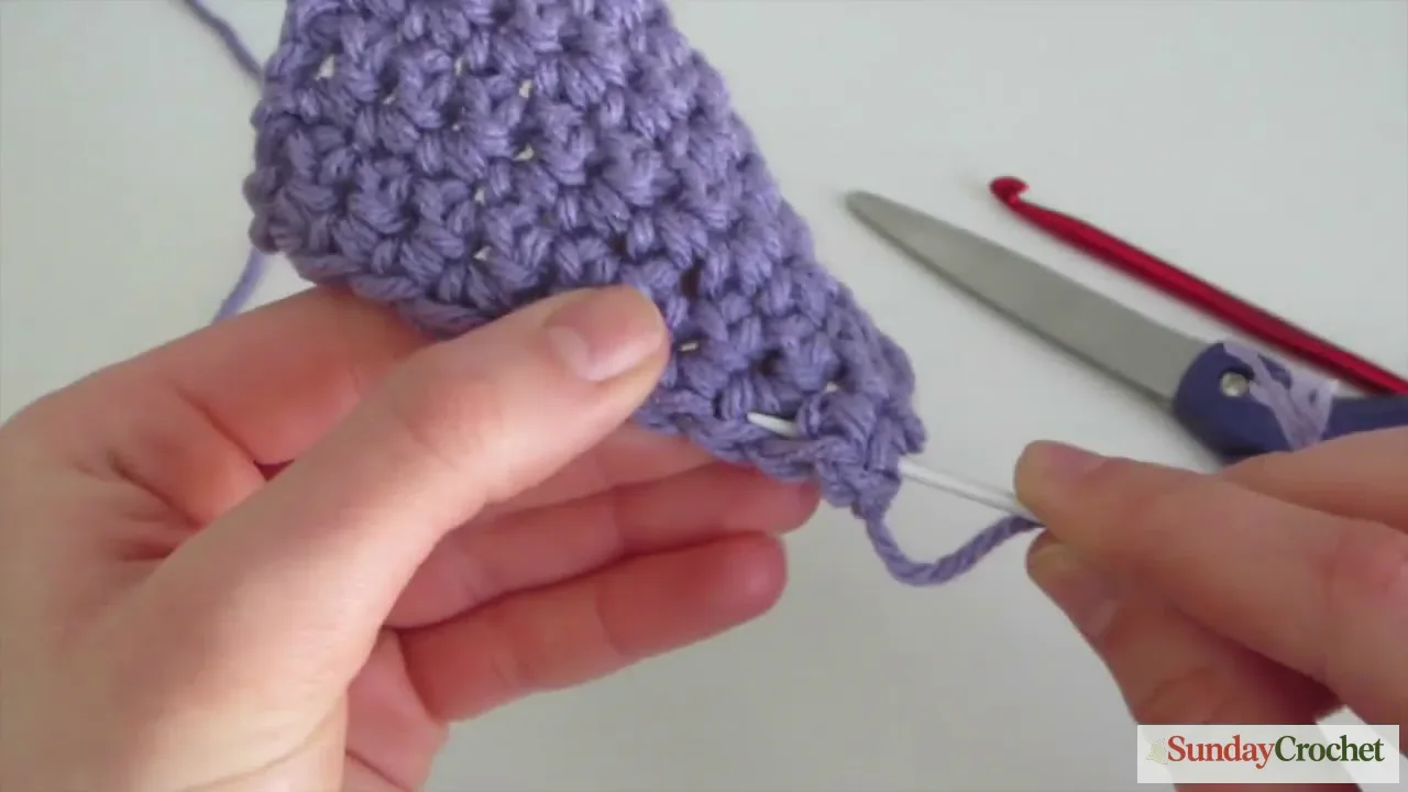 Weave in loose crochet ends with a yarn needle to finish a swatch