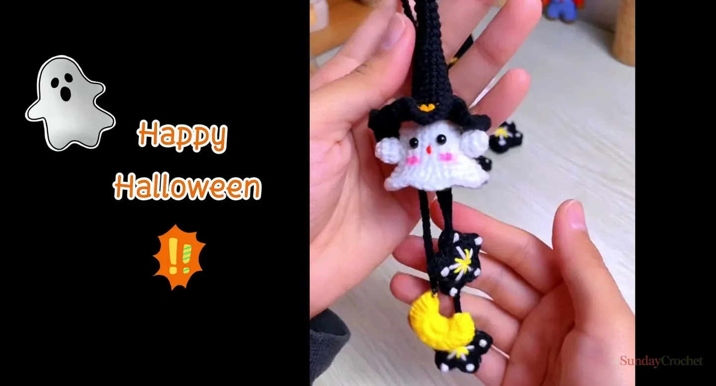 Finished white crochet ghost wearing a tall black witch hat and holding a yellow moon and star charm