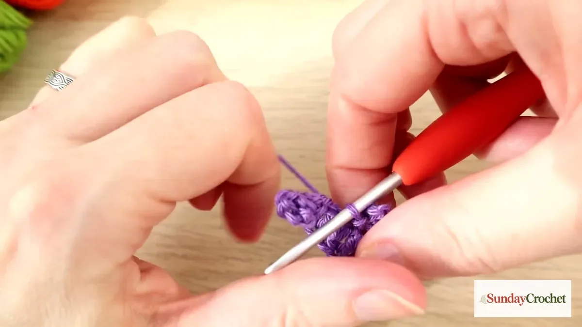 Close-up of the purple bat applique as a chain-three picot ear is formed at the center