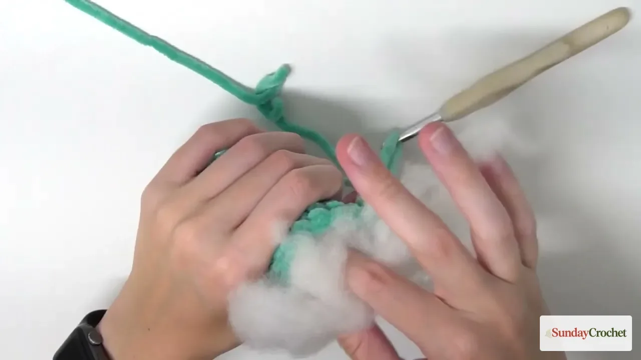 A small amount of stuffing is added to the crocheted snake body so it stays soft and flexible