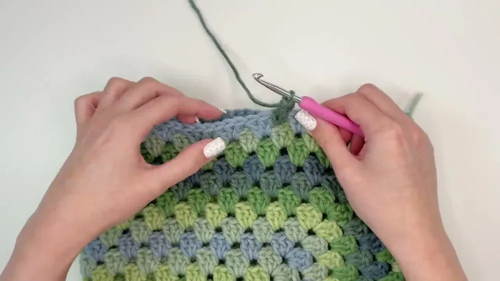 Three-double-crochet clusters are worked around the open sleeve edge to add length