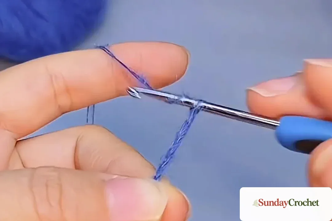 Blue yarn foundation chain being worked to eight stitches on a crochet hook