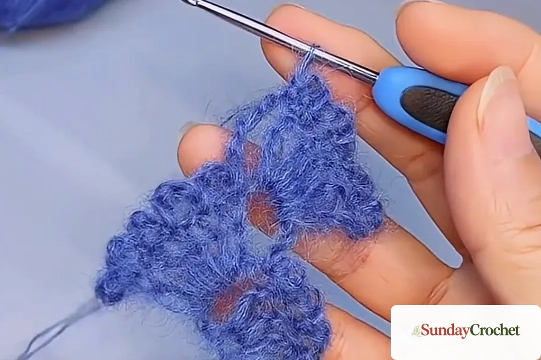 Growing blue scarf with alternating fan motifs and open chain spaces