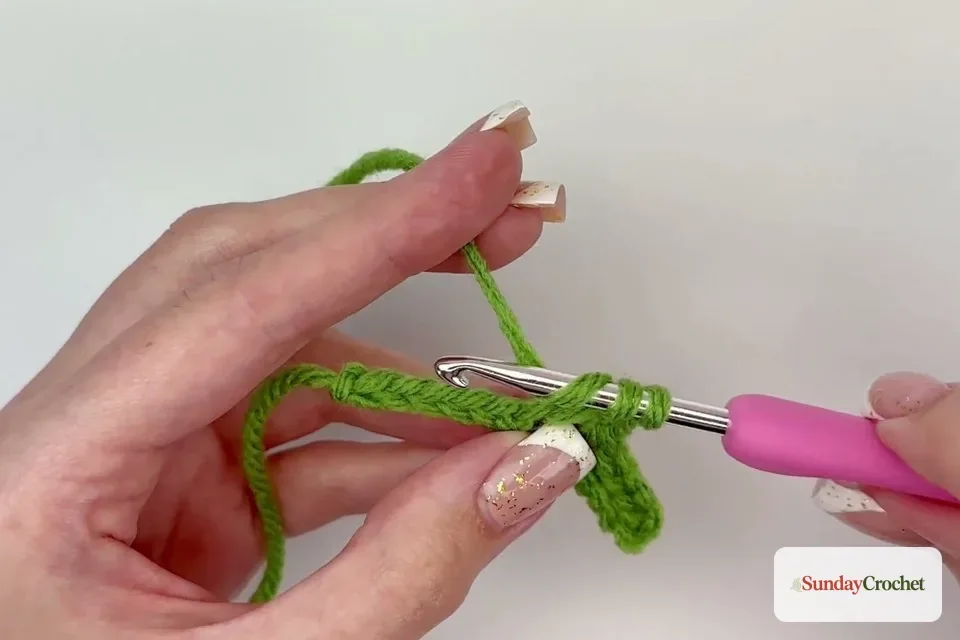 A tall triple crochet forms the pointed center of the crocheted leaf