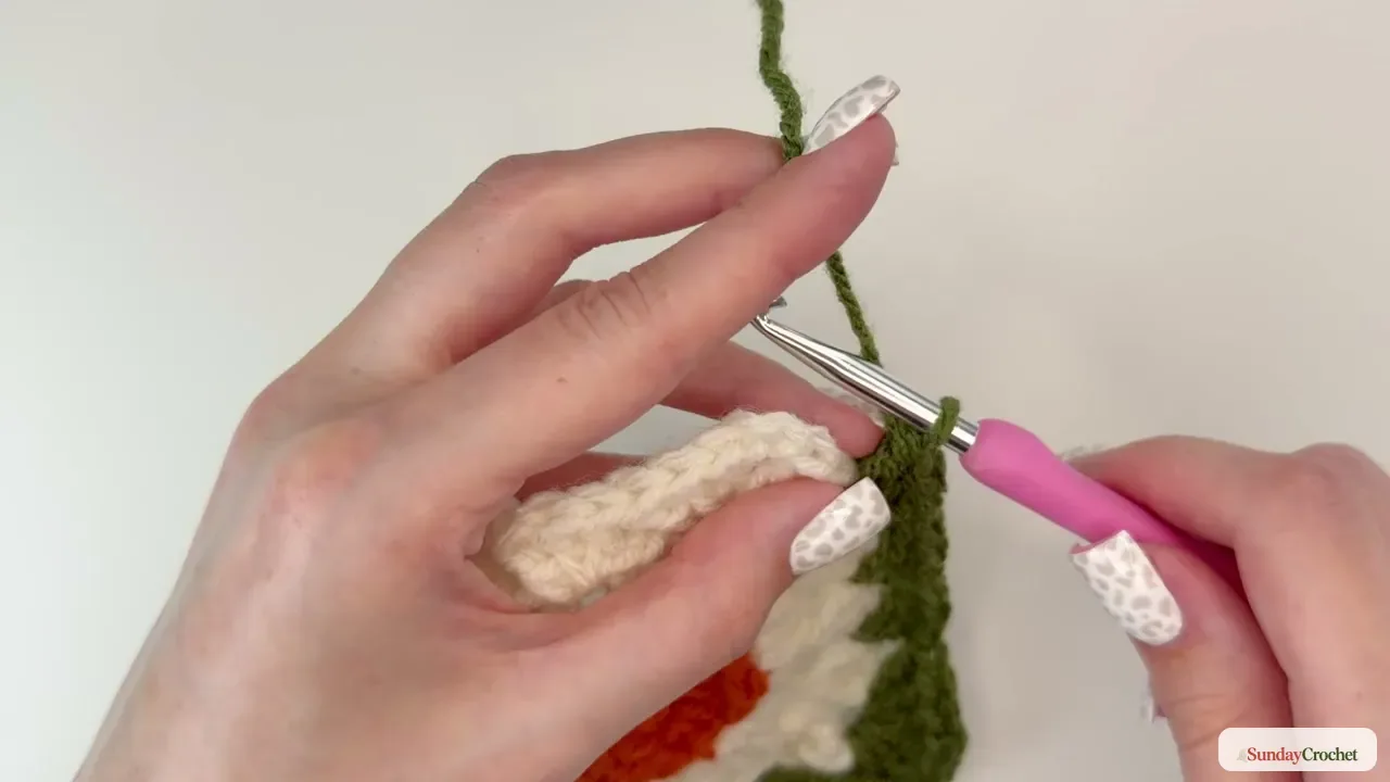 Green granny-stitch border worked around the cream pumpkin motif