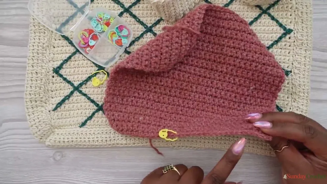 A crochet panel is laid flat and marked to plan the diamond lattice placement