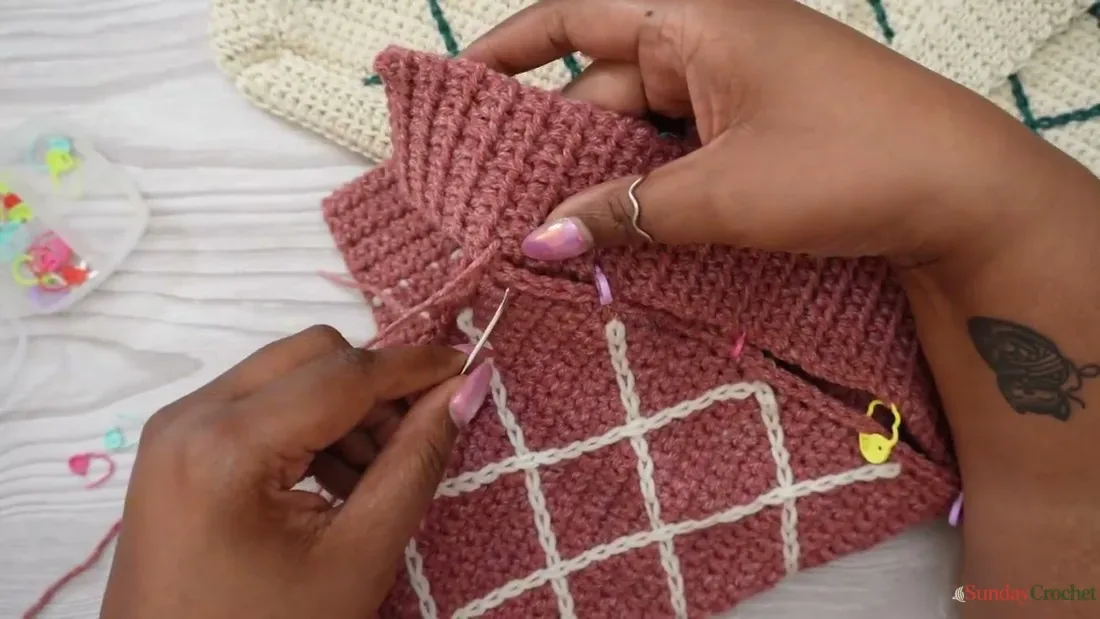 A tapestry needle sews the crochet strap to the side of the lattice tote