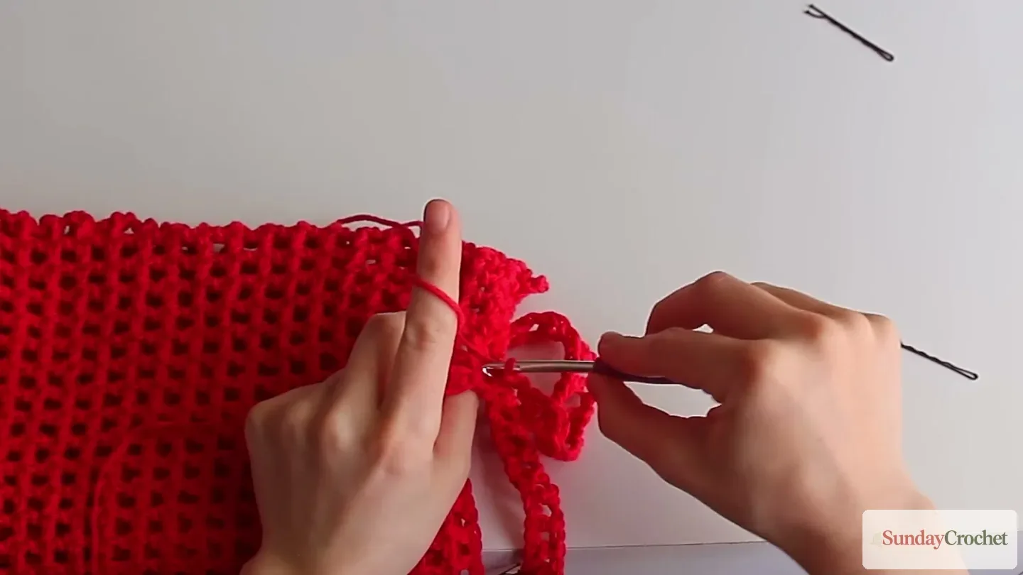 Slip stitches are worked along the crochet strap to reinforce its edges
