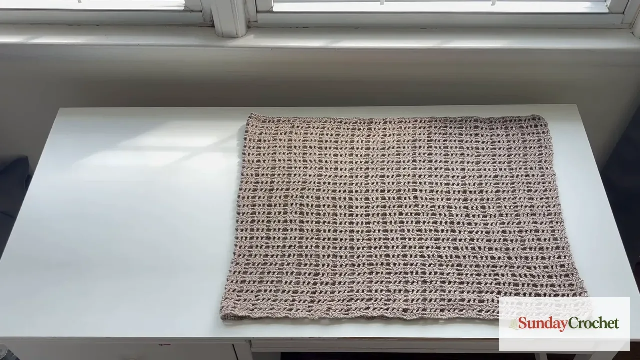 Finished taupe mesh poncho rectangle laid flat before folding
