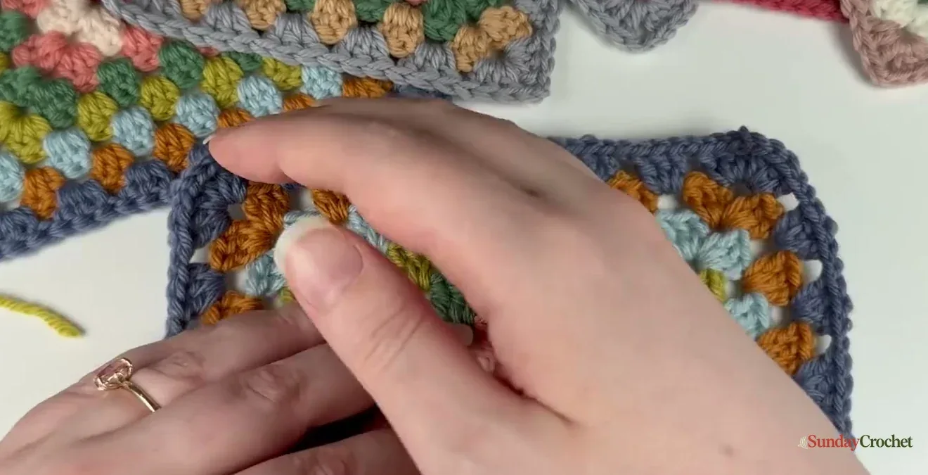 The granny square is turned over before the next round begins