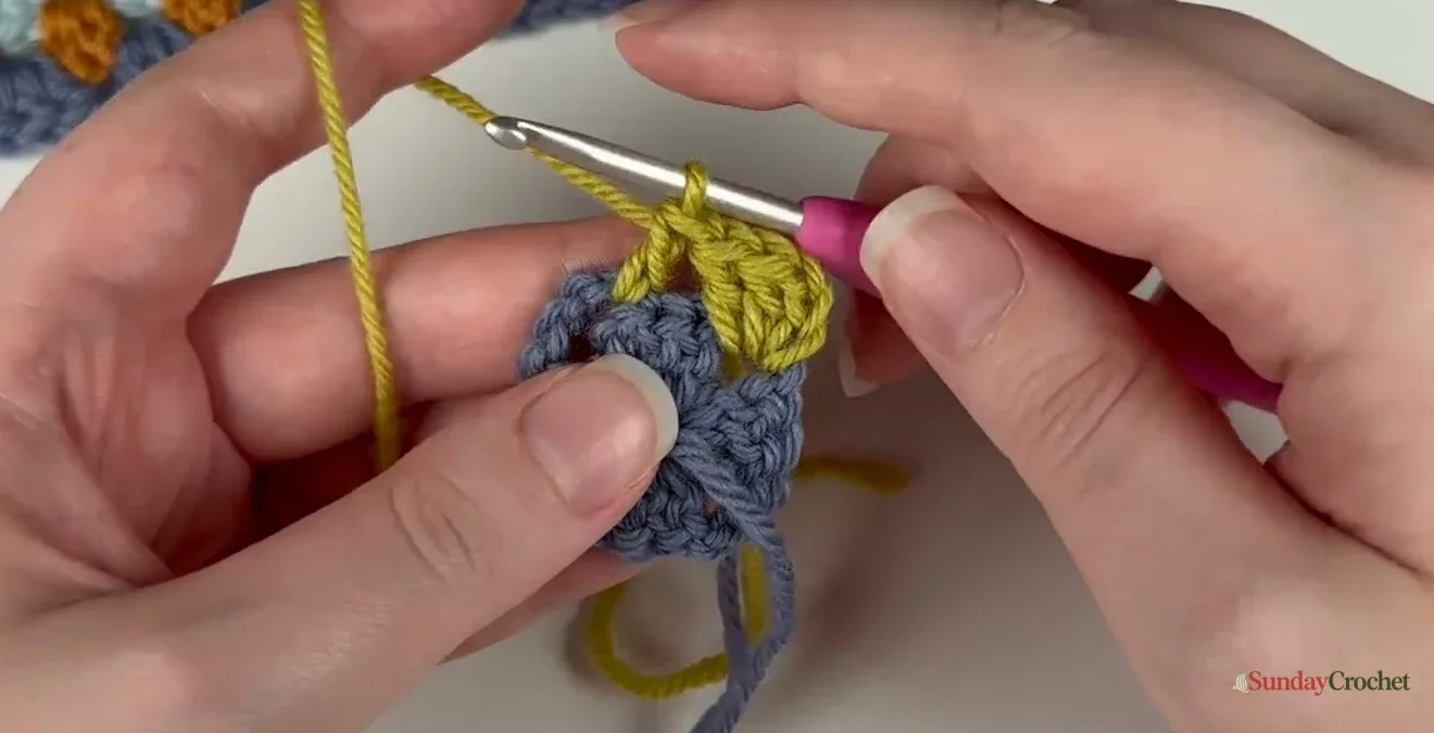 Two chains form the corner space between double-crochet clusters