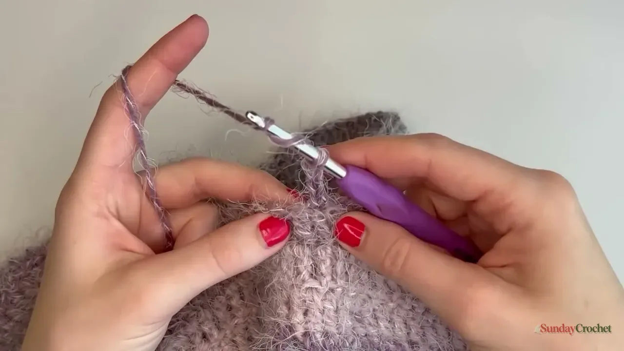 A close-up shows the hook working into a raglan V and its chain space on the sweater yoke