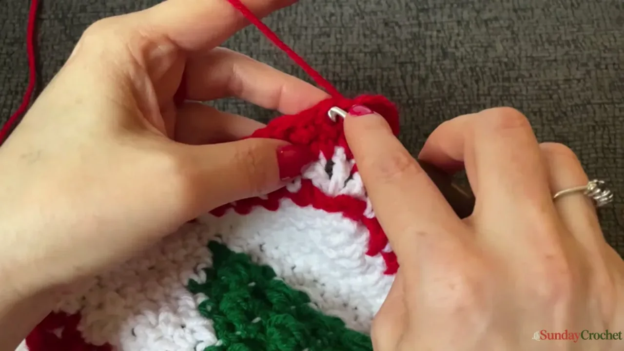 The red and cream edging is finished along the outside of a joined Christmas tree blanket