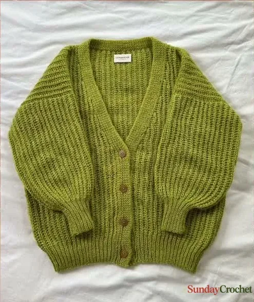 Olive-green crochet cardigan with a deep V-neck, wooden buttons, roomy sleeves, and ribbed cuffs laid flat